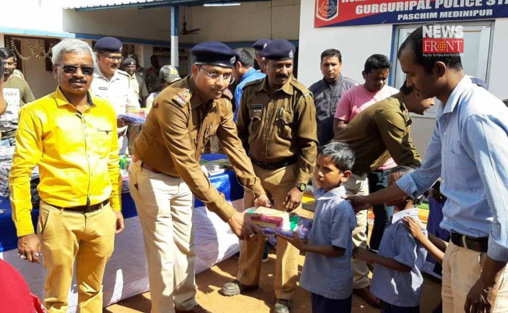 police officer distribute studies materials to students | newsfront.co