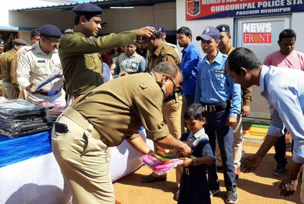 police officer distribute studies materials to students | newsfront.co